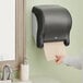 A black Tork electronic touch-free automatic hand towel dispenser.