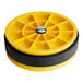 A yellow and black circular object with a black center.