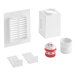 A white plastic box with a red lid and a white lid containing a white plastic Oatey Sure-Vent air admittance valve and a red plastic tube.