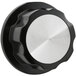 A black and silver thermostat knob with a round metal plate.