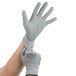 A pair of hands wearing gray Cordova Valor gloves.