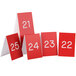 A group of red Cal-Mil table tents with white numbers