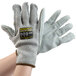 A pair of Cordova Monarch gray and yellow heavy duty work gloves with a label on them.