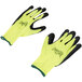 A pair of small Cordova work gloves with yellow and black fabric and green foam latex palms.