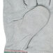 A Cordova warehouse glove with green and pink stripes, gray leather palms, and starched cuffs.