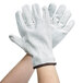 A pair of white Cordova leather gloves with black stitching.