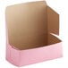 A Baker's Mark pink cardboard bakery box with the lid open.
