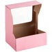 A pink Baker's Mark bakery box with a window.