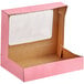 A pink Baker's Mark bakery box with a clear window.