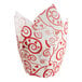 A white cupcake wrapper with red swirls and hearts.