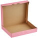 A pink Baker's Mark bakery box with the lid open.