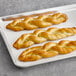 A tray of J & J Snack Foods SuperPretzel Soft Pretzel Braids.
