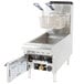 An APW Wyott natural gas countertop fryer with a door open and a basket inside.