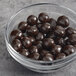 A bowl of Albanese dark chocolate covered pretzel balls.