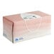 A pink Puffs facial tissue box with a white label and lid.