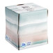 A white Puffs facial tissue cube with a watercolor design on the box.