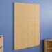 A Flash Furniture plastic peg system wall panel on a wall.