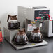 A Grindmaster automatic coffee brewer with two coffee pots on top.