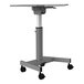 A grey height-adjustable student desk with wheels.