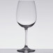 A clear Stolzle Weinland wine glass on a white surface.