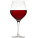 A Stolzle Exquisit burgundy wine glass filled with red wine.