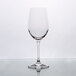 A clear Stolzle Chardonnay wine glass on a reflective surface.