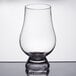 A close-up of a Stolzle Glencairn whiskey glass with a small rim.