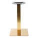 A gold square stainless steel table base.