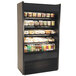 A black Structural Concepts Oasis air curtain merchandiser refrigerator with food on shelves.