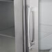 The right hinged stainless steel glass door of a Traulsen reach in refrigerator.