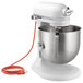 A white KitchenAid bowl lift countertop mixer with standard accessories.