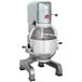An Avantco 30 qt. planetary floor mixer with a guard and standard accessories on a metal stand.