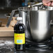 Shank's Premium Pure Vanilla Extract being poured into a mixing bowl.