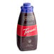 A close up of a Torani Sugar-Free Dark Chocolate Flavoring Sauce bottle with a blue lid.