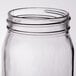 A close-up of a clear Libbey Mason jar with a lid.