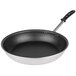 A close-up of a Vollrath Wear-Ever aluminum non-stick frying pan with a black and silver design.