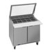 A Beverage-Air Elite Series refrigerated sandwich prep table with a glass top and two doors.