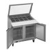 A Beverage-Air stainless steel refrigerated sandwich prep table with two glass doors open.