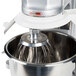 A Vollrath wire whisk attachment in a metal bowl on a Vollrath mixer.