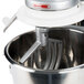 A close-up of a Vollrath mixer with a Vollrath cast aluminum flat beater attached to the mixer.