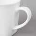 A close-up of a 10 Strawberry Street Whittier white porcelain mug with a handle.