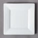 A 10 Strawberry Street Whittier white square porcelain salad/dessert plate with a small rim on a gray surface.