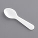 A white plastic Choice spoon on a gray surface.