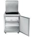 A Traulsen stainless steel refrigerated sandwich prep table with a door open.