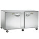 A large silver Traulsen undercounter freezer with left and right hinged doors.
