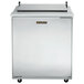 A stainless steel Traulsen sandwich prep table with a black handle on a left hinged door.