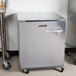 A Traulsen undercounter refrigerator with a stainless steel left hinged door.
