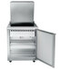 A stainless steel Traulsen refrigerated sandwich prep table with a door open.