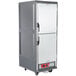 A gray Metro C5 heated holding cabinet with Dutch doors on wheels.