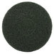 A green circular Scrubble floor pad with a hole in the middle.
